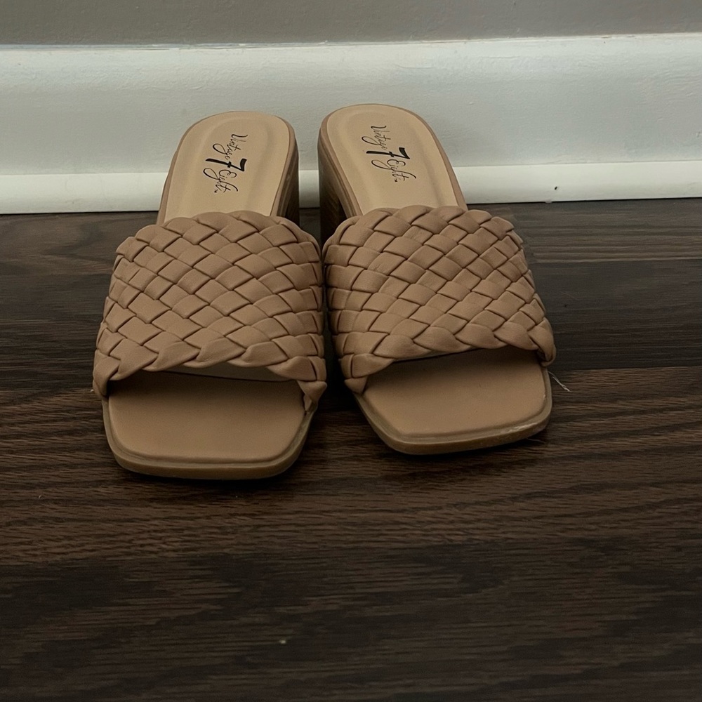 Nude colored slip on wedge heel.